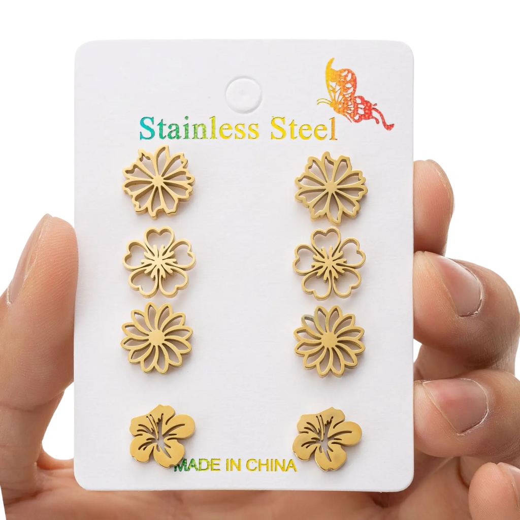Gold-toned stainless steel flower-shaped stud earrings displayed on a white card from a 6-piece floral earring set
