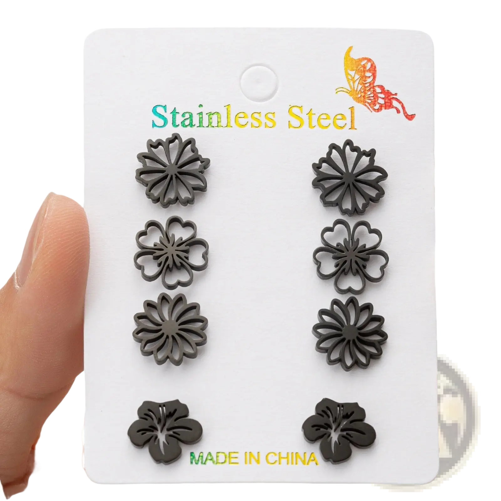 Set of six black stainless steel floral stud earrings displayed on a white card in a 6-piece earring set