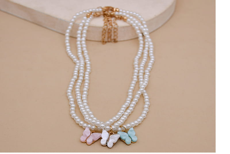 Elegant pearl butterfly charm choker necklace featuring a delicate triple-strand design with pastel-colored butterfly charms in pink white and light blue pearls.