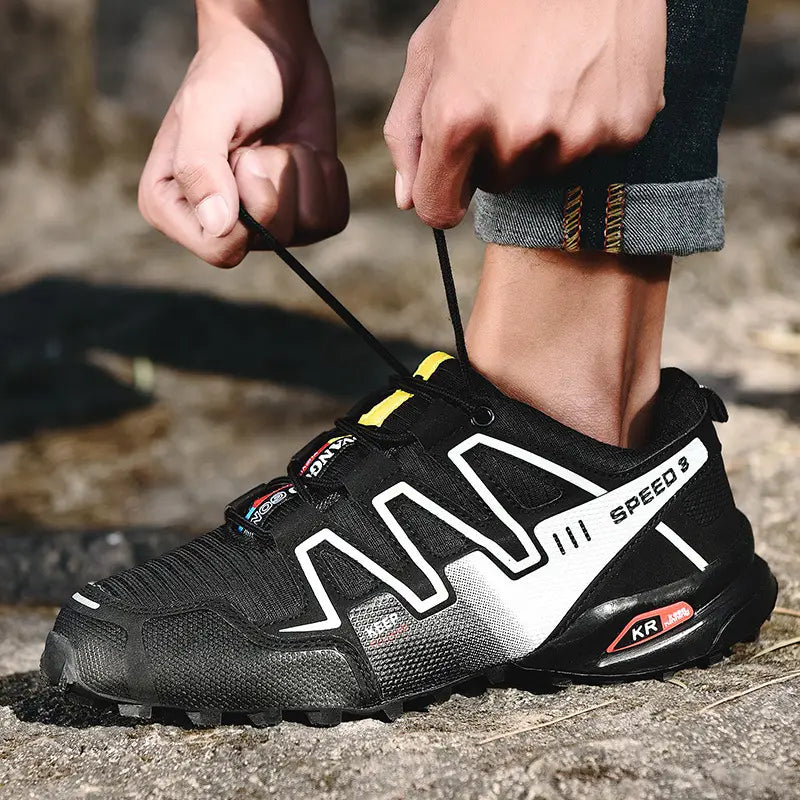 Men’s trail running shoe salomon speed 3 in black and white with breathable textured mesh upper bold geometric branding and rugged outsole for outdoor use.