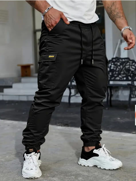 Men’s slim fit cropped black cargo joggers with drawstring waist side pockets and subtle gold logo patch on the thigh.
