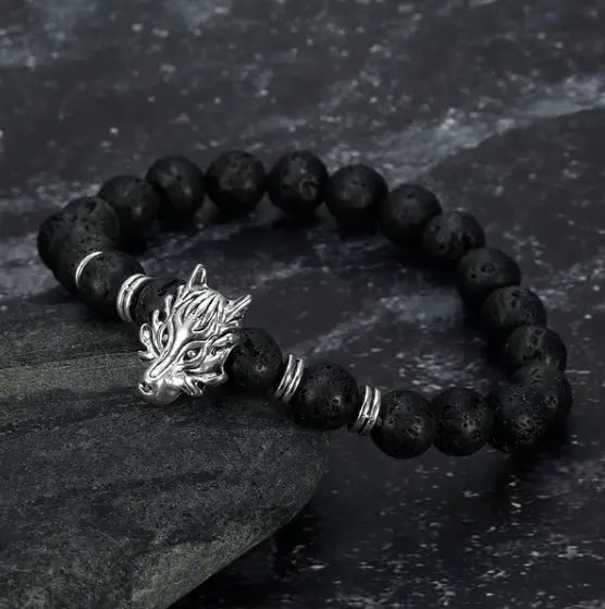Black lava stone bracelet featuring a silver wolf head clasp and metallic spacer beads called the Asgard wolf head lava stone bracelet.