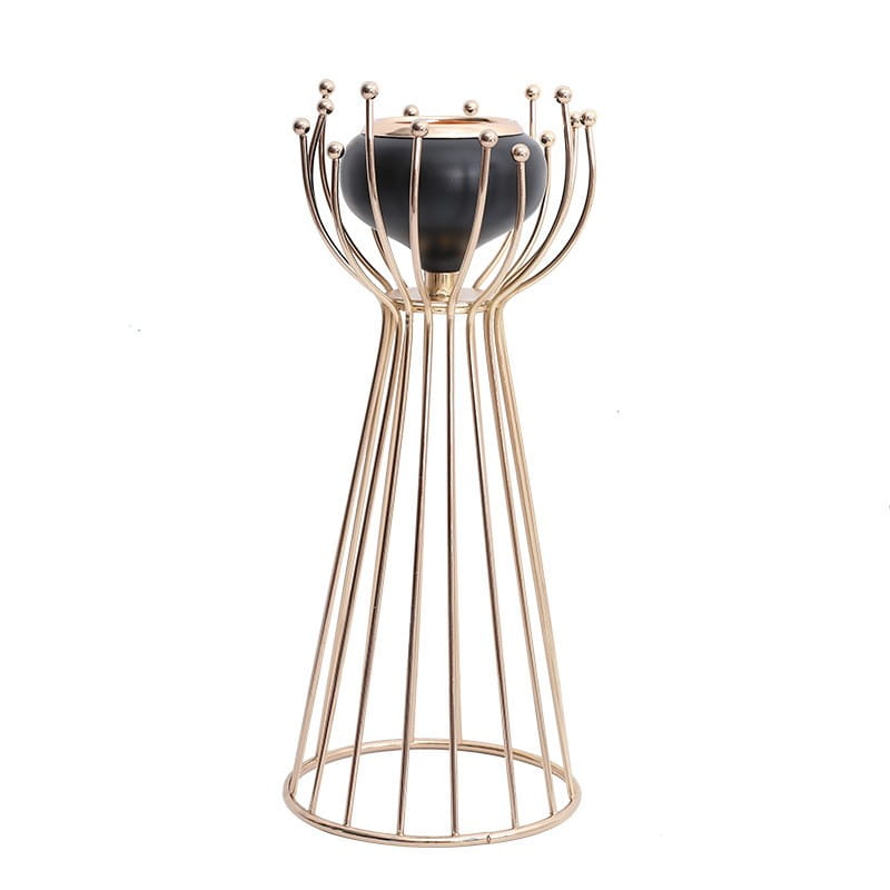 Gold geometric wire cage candle holder with black base featuring a gold-toned metal sleek modern design with slender vertical rods and spherical accents at the top.