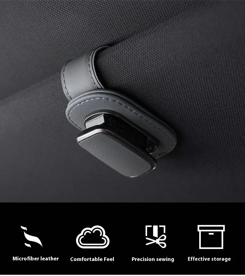 Black microfiber leather car glasses clip holder with sleek minimalist design and precise stitching for car seat headrest attachment.