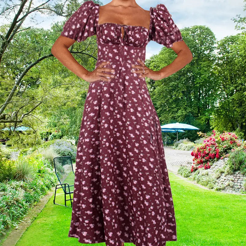 A woman wears a burgundy floral midi slit dress with puffed short sleeves and a square neckline.
