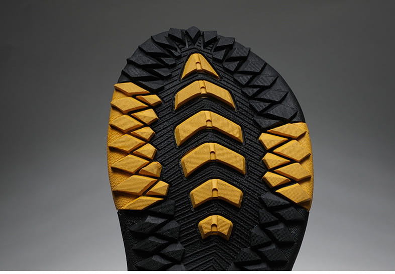 men’s leather beach sandals outdoor sport flip flops showing the black and yellow rubber shoe sole with a rugged textured tread pattern.
