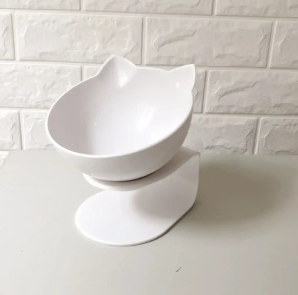 White ceramic elevated cat bowl with a sleek modern design featuring two pointed ears on the rim and a 15 degree tilt for easy feeding.