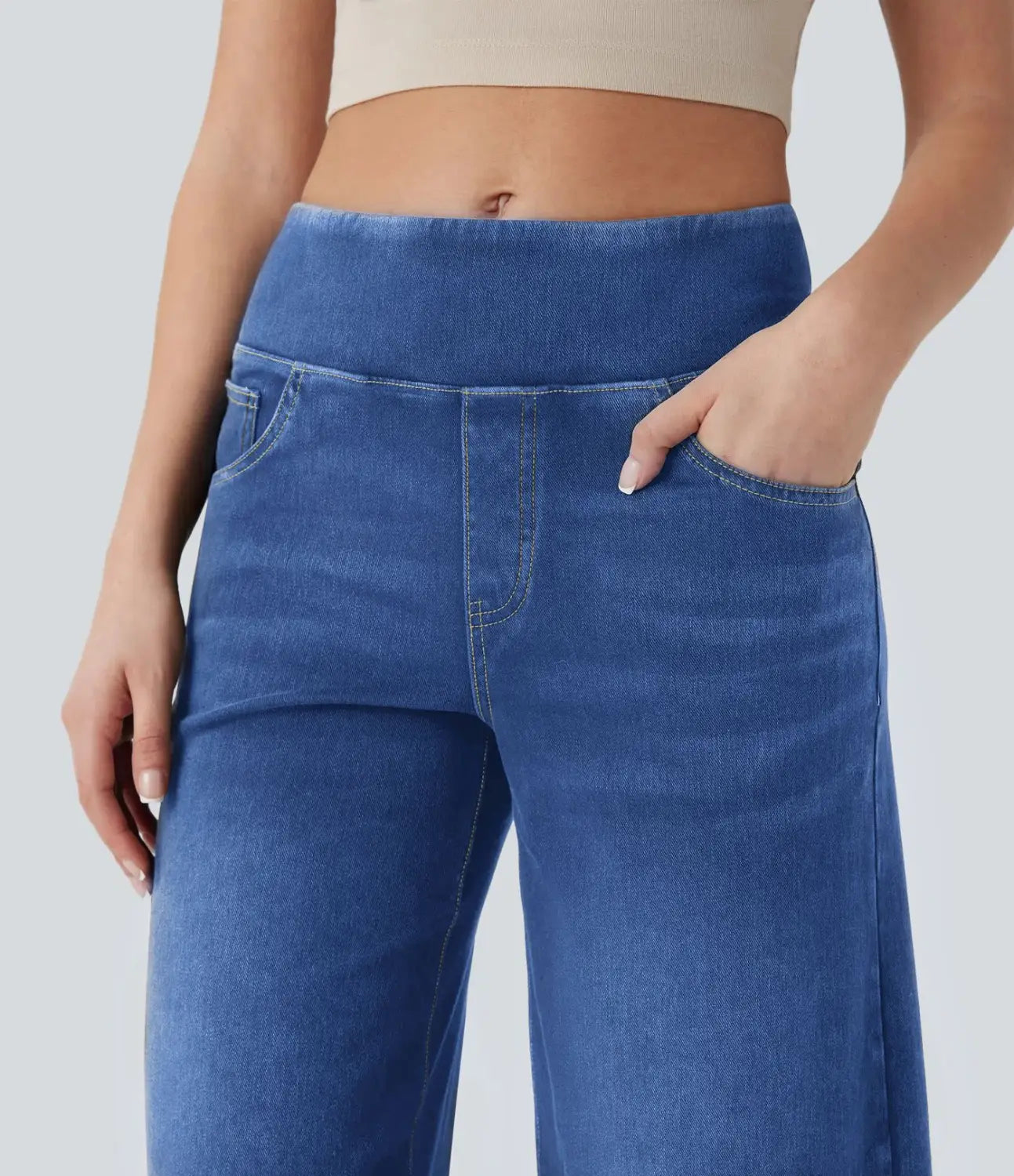 Blue denim wide leg stretchy high waisted jeans featuring a comfortable elastic waistband and classic front pockets.