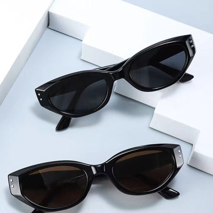 Black cat-eye uv400 sunglasses with glossy modern frames dark lenses and silver rivets on the temples.