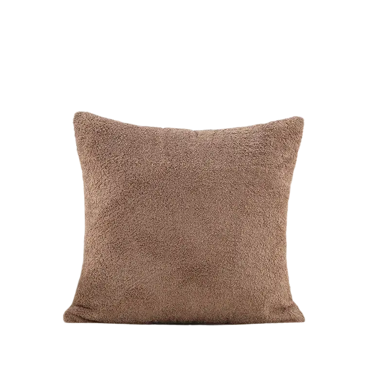 A cozy taupe 60x60cm cushion cover made of solid teddy velvet on a cream tufted sofa with plush texture