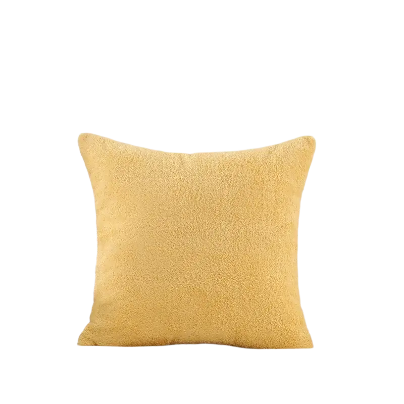 A soft yellow 60x60cm cushion cover made of plush teddy velvet fabric on a light tufted sofa armrest