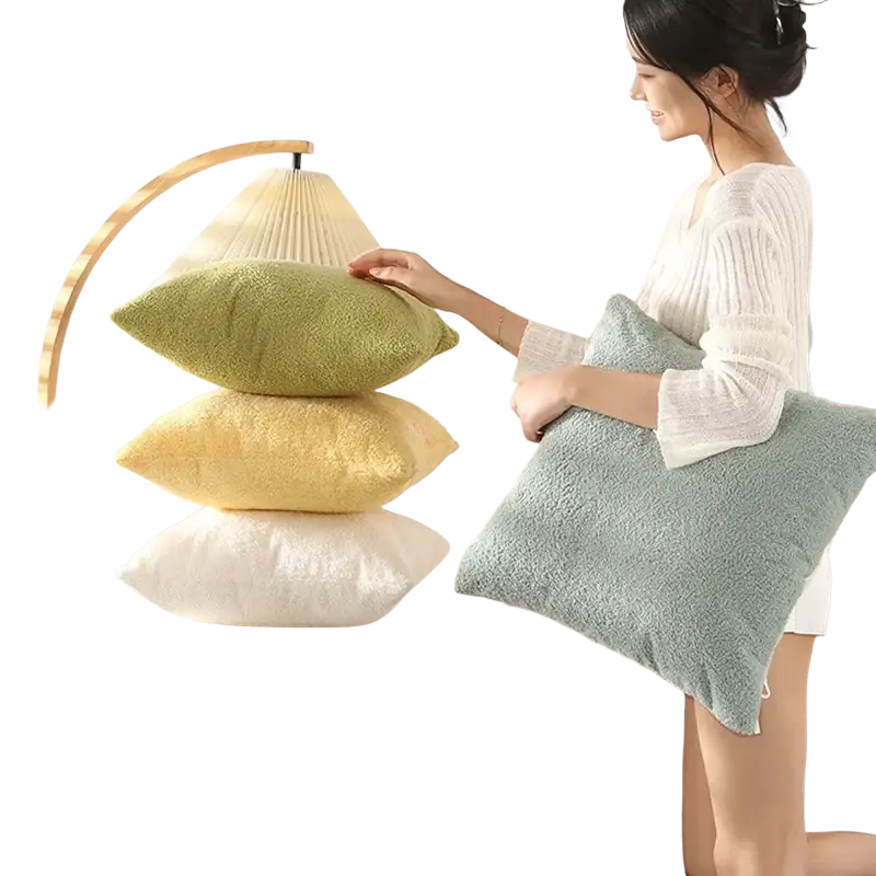Stack of plush 60x60cm cushion covers in muted green yellow and white tones made of solid teddy velvet material