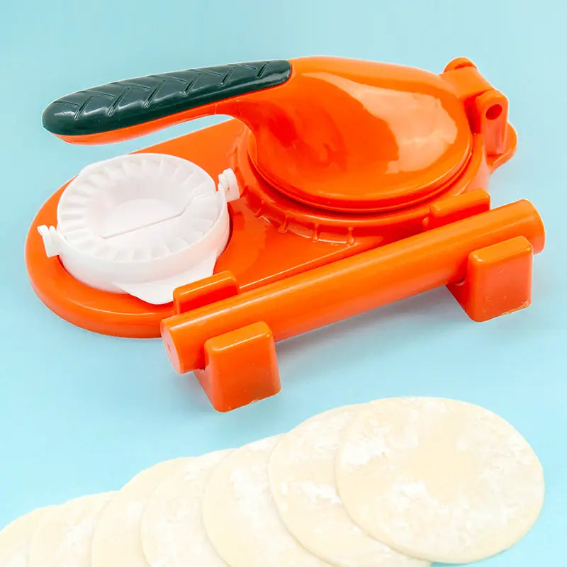 Bright orange plastic dumpling maker 3 in 1 manual dough pressing tool with a black textured handle and white circular mold designed for pressing dough into uniform circles.