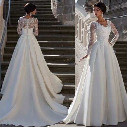a flowing ivory wedding dress with long lace sleeves and a delicate lace back detail shown from the back side