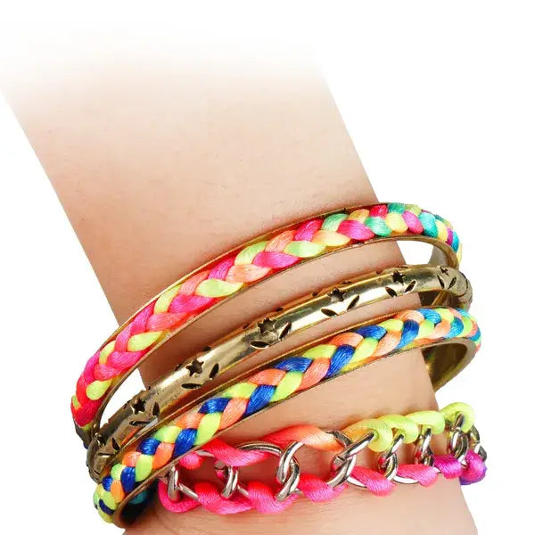 A vibrant neon braided bracelet with pink yellow and blue threads wrapped around a gold-toned metal bangle with star cutouts from a 4 piece neon braided bangle set with gold star accents.