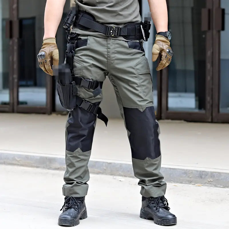 pantalon tactique ix6 pour hommes, modèle cargo utilitaire pour l’été, en vert olive, avec panneaux de genou renforcés noirs et plusieurs poches utilitaires.
