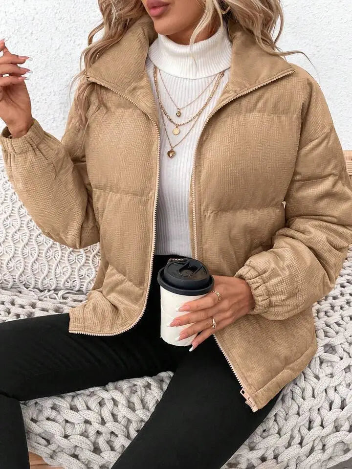 Tan corduroy puffer jacket for plus size women with quilted design and ribbed cuffs ideal for winter wear.