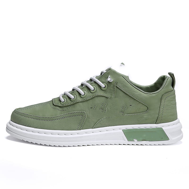 Olive green leather low-top canvas sneaker with white laces and contrasting white rubber sole with matching olive green accent panel designed for casual sports use.