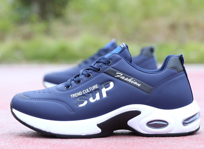Men’s casual sportswear leather running shoes in navy blue with white and black accents featuring a cushioned sole and trend culture sup branding on the side.