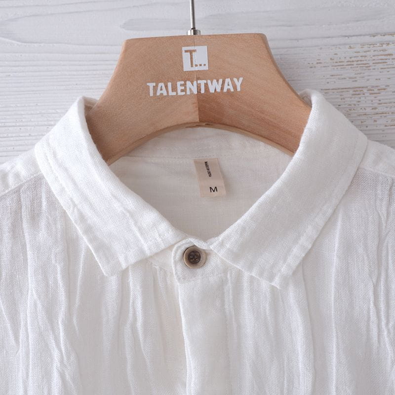 Men’s retro distressed white linen short sleeve shirt featuring a classic collar and a single brown button at the placket.
