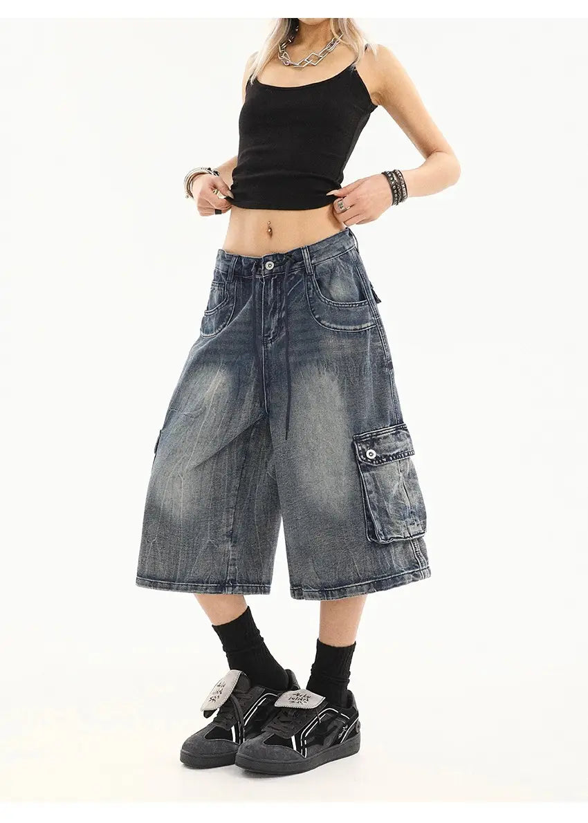 Pantalones cargo de mezclilla azul de pierna recta de estilo urbano, con shorts cargo de mezclilla desgastada en un lavado azul desvaído, múltiples bolsillos y un corte amplio y relajado de pernera.