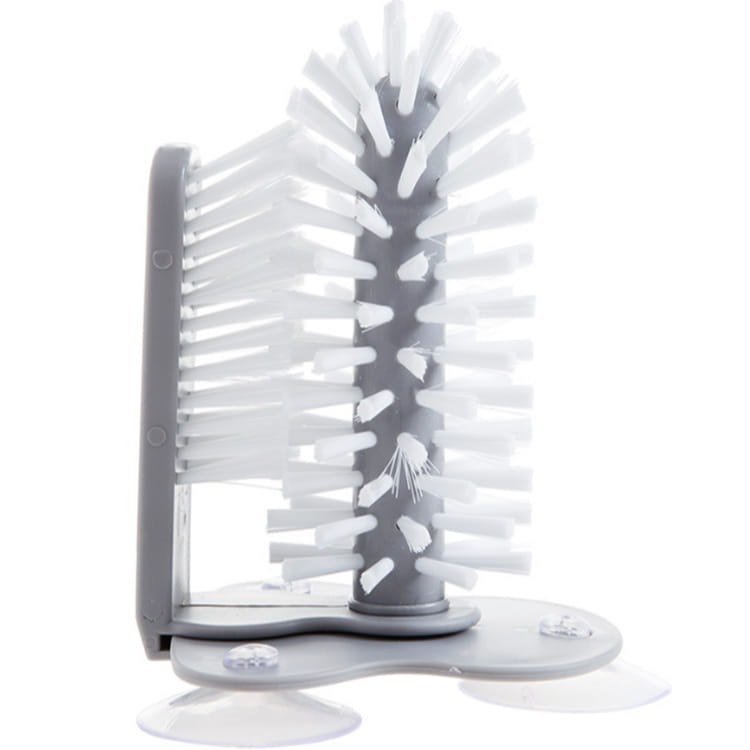 gray plastic glass cleaning brush with white radial bristles and clear suction cups for attachment in a sink scrubber design