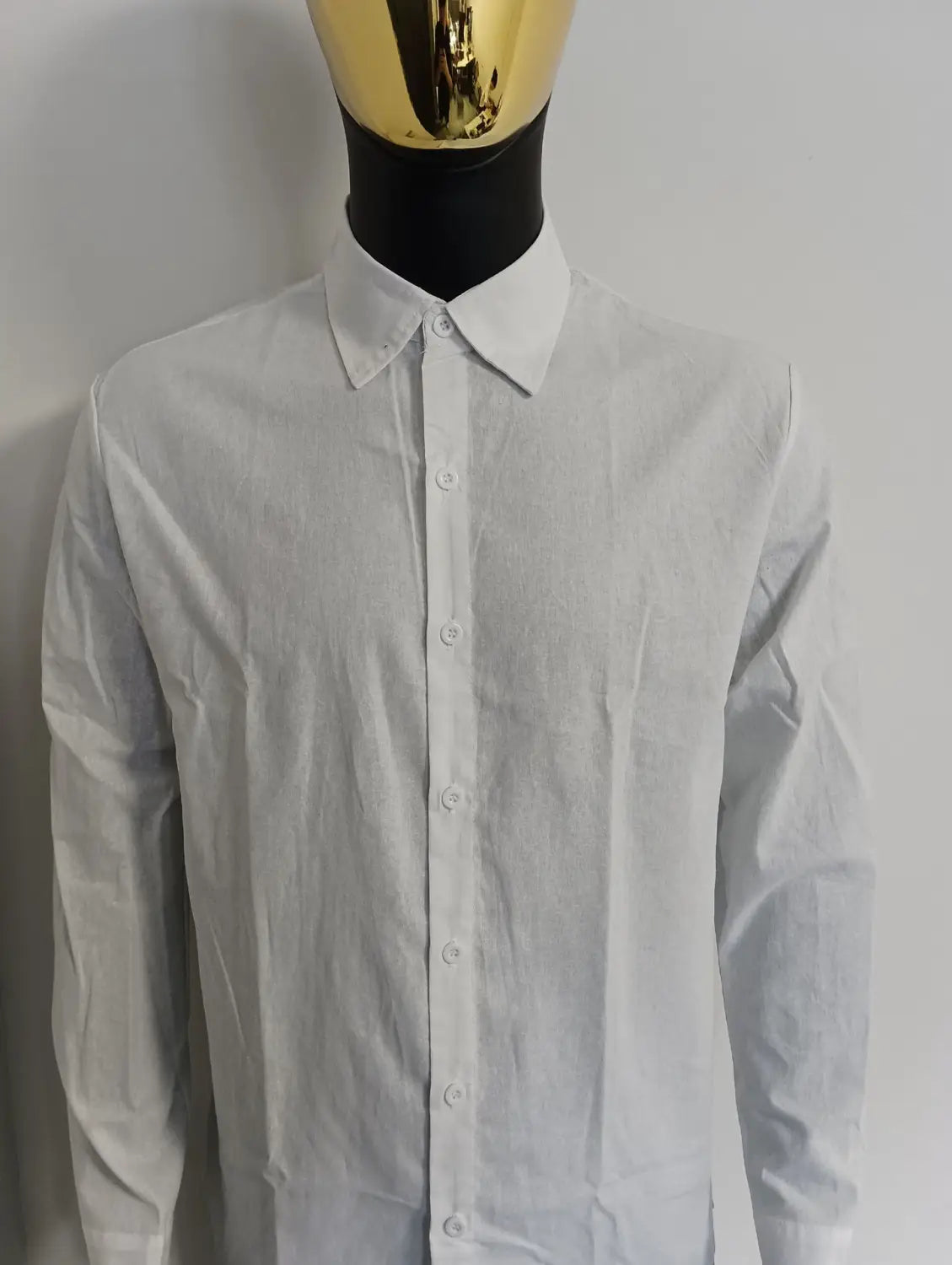 A crisp white mens cotton long sleeve casual button down shirt with a classic collar and neatly aligned buttons.