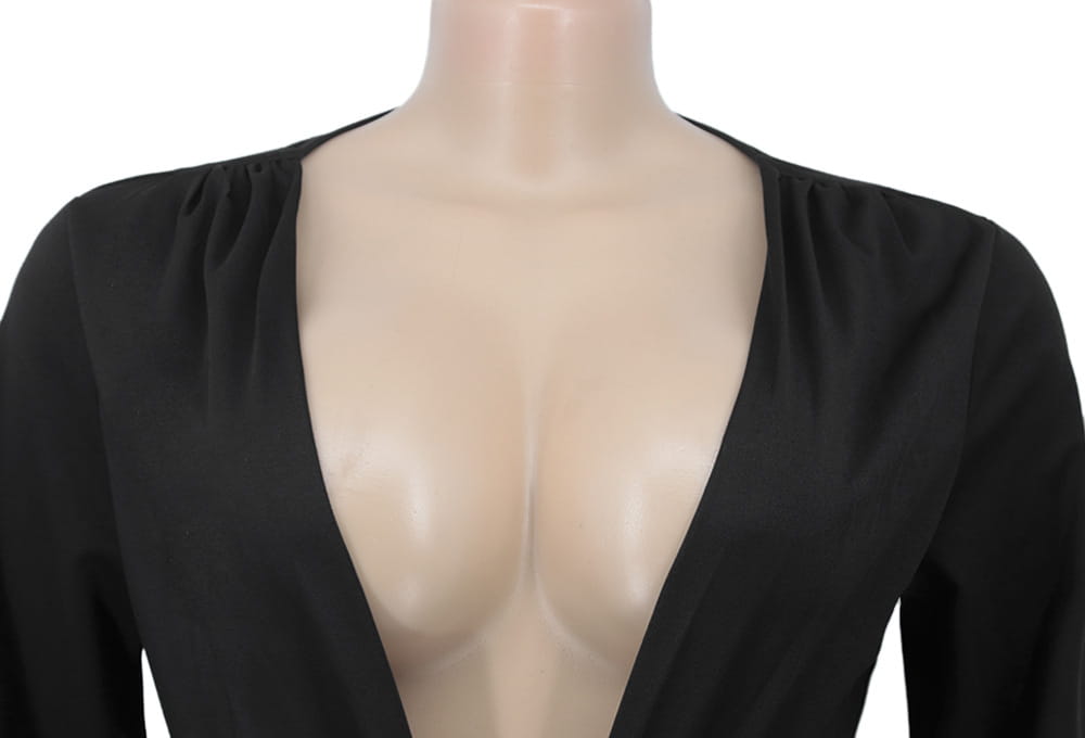 Black velvet v-neck evening dress with long sleeves, deep v-neckline, and gathered shoulders.