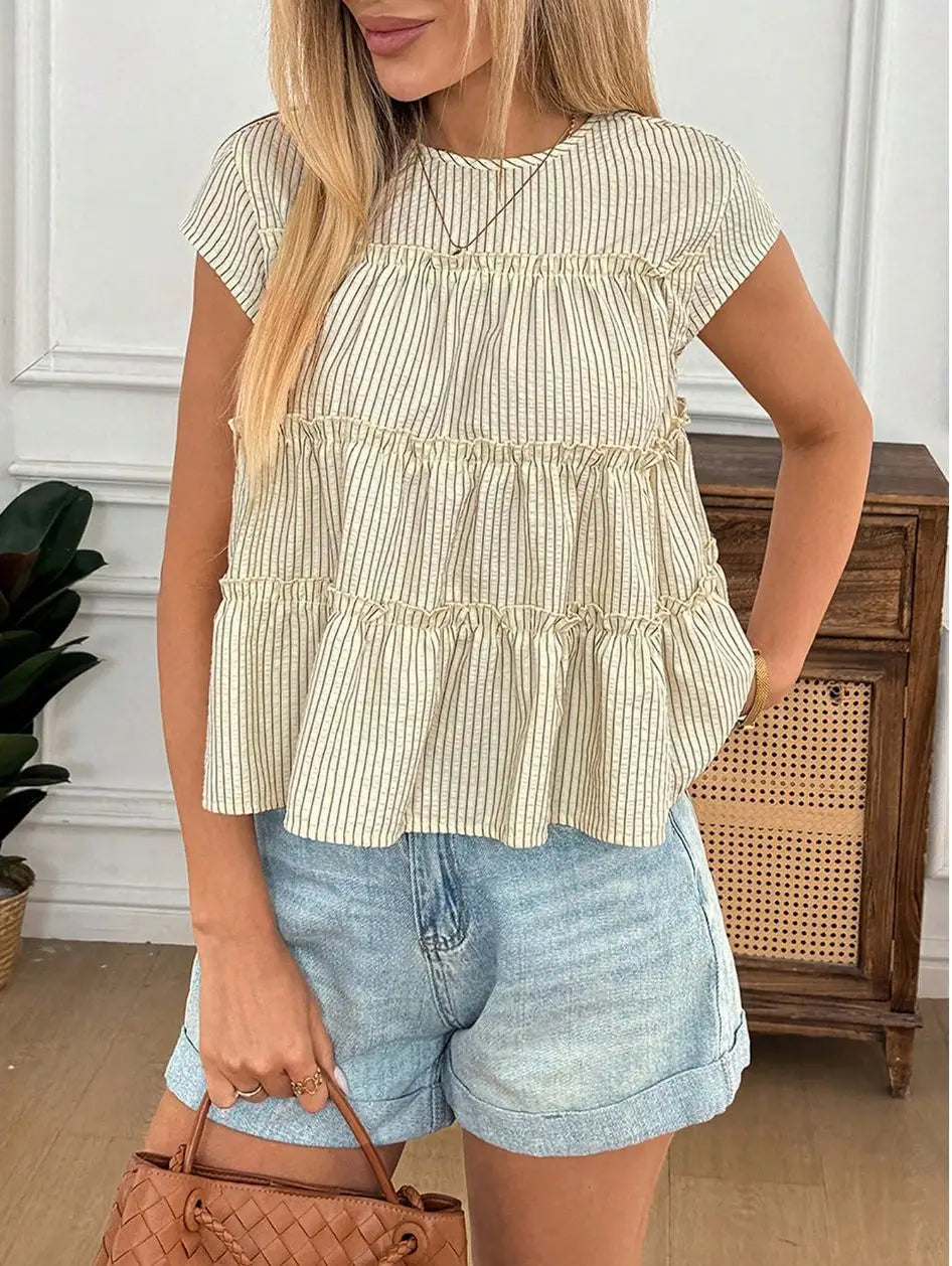 A tiered striped ruffle hem blouse in beige featuring light green and white vertical stripes short sleeves and a gathered ruffled hem.