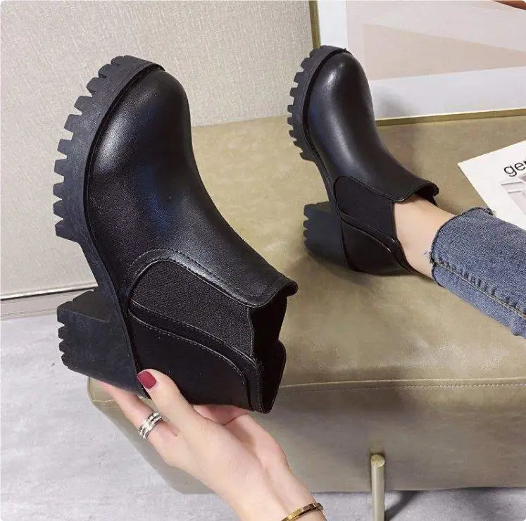 women’s black leather chunky heel ankle boots featuring a low block heel and a chunky textured sole