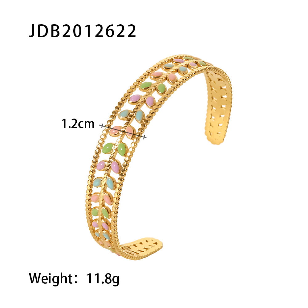 Gold plated stainless steel zirconia gemstone bangle bracelet featuring a gold-colored open cuff design adorned with alternating pink and green enamel leaf motifs along a beaded edge.