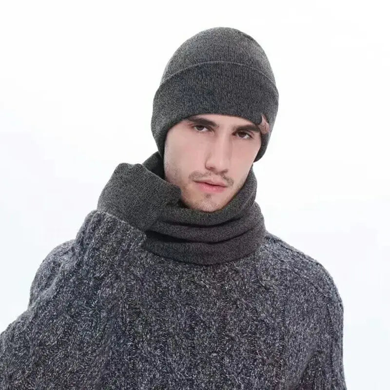 Dark gray knitted beanie and matching scarf set featuring textured heathered fabric and ribbed cuffs for winter wear.