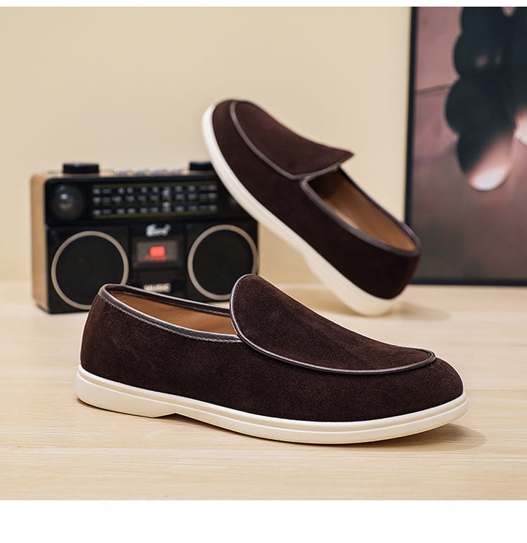 Men’s brown suede slip on loafers with white rubber sole and contrasting stitching.