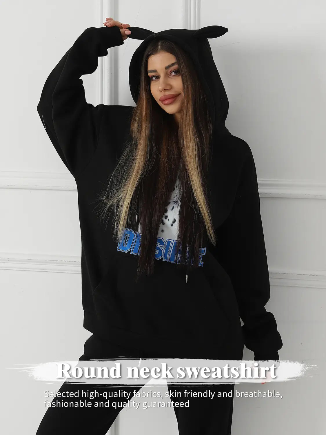 women’s black hooded sweatshirt featuring bunny ear trim and a blue graphic print on the front designed as a dalmatian print hoodie with cat ear hood.
