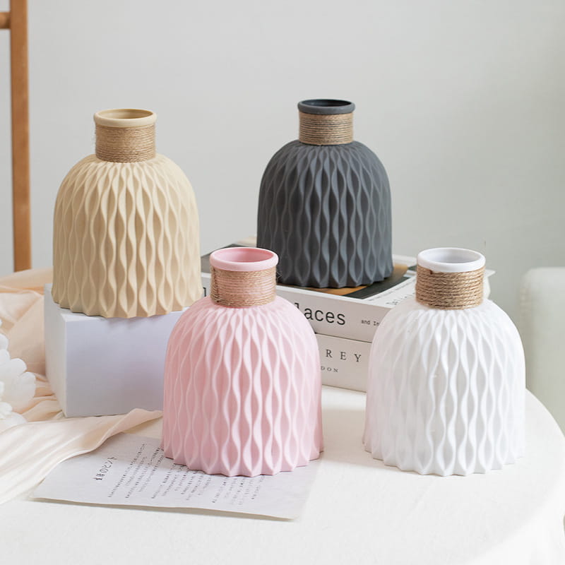 Ceramic vase set with twine and wavy texture in beige gray pink and white featuring textured wavy patterns and natural twine wrapped necks.