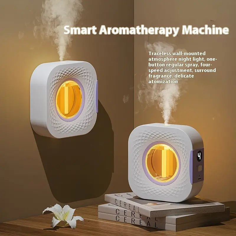 White square-shaped smart aromatherapy machine with textured surface, glowing amber interior light, and purple accent details for rechargeable wall mounted diffuser use.