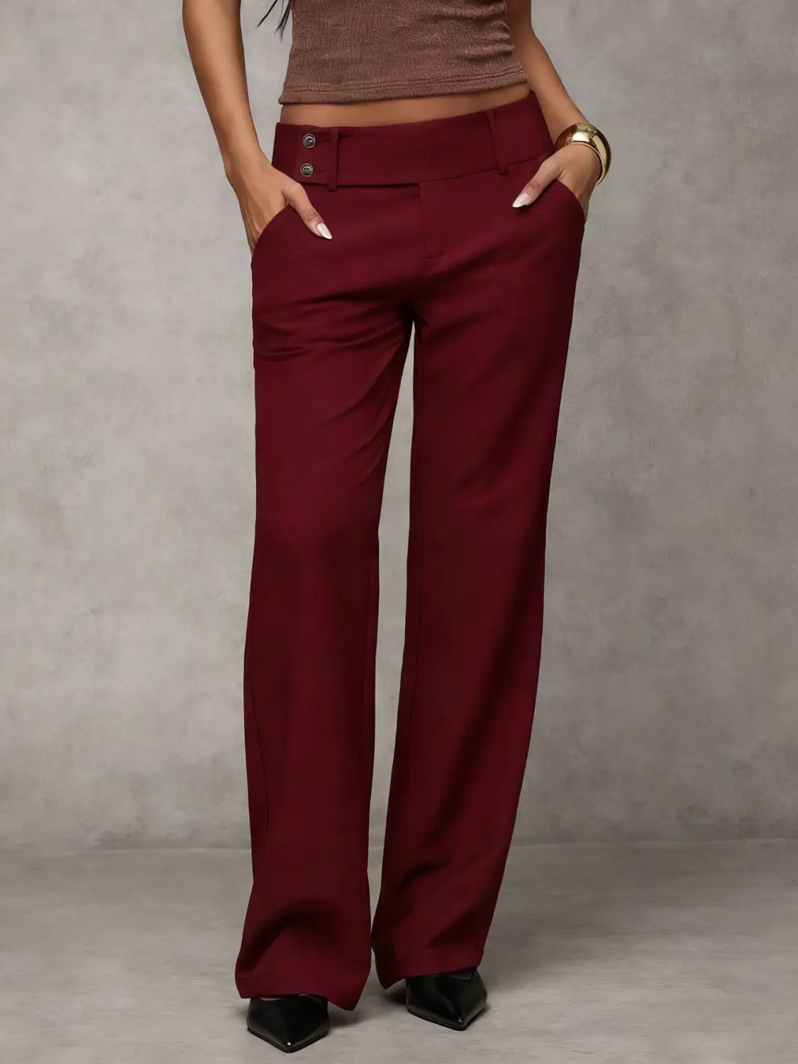 Burgundy wide leg work pants with a high waist and buttoned front detail suitable for casual wear.