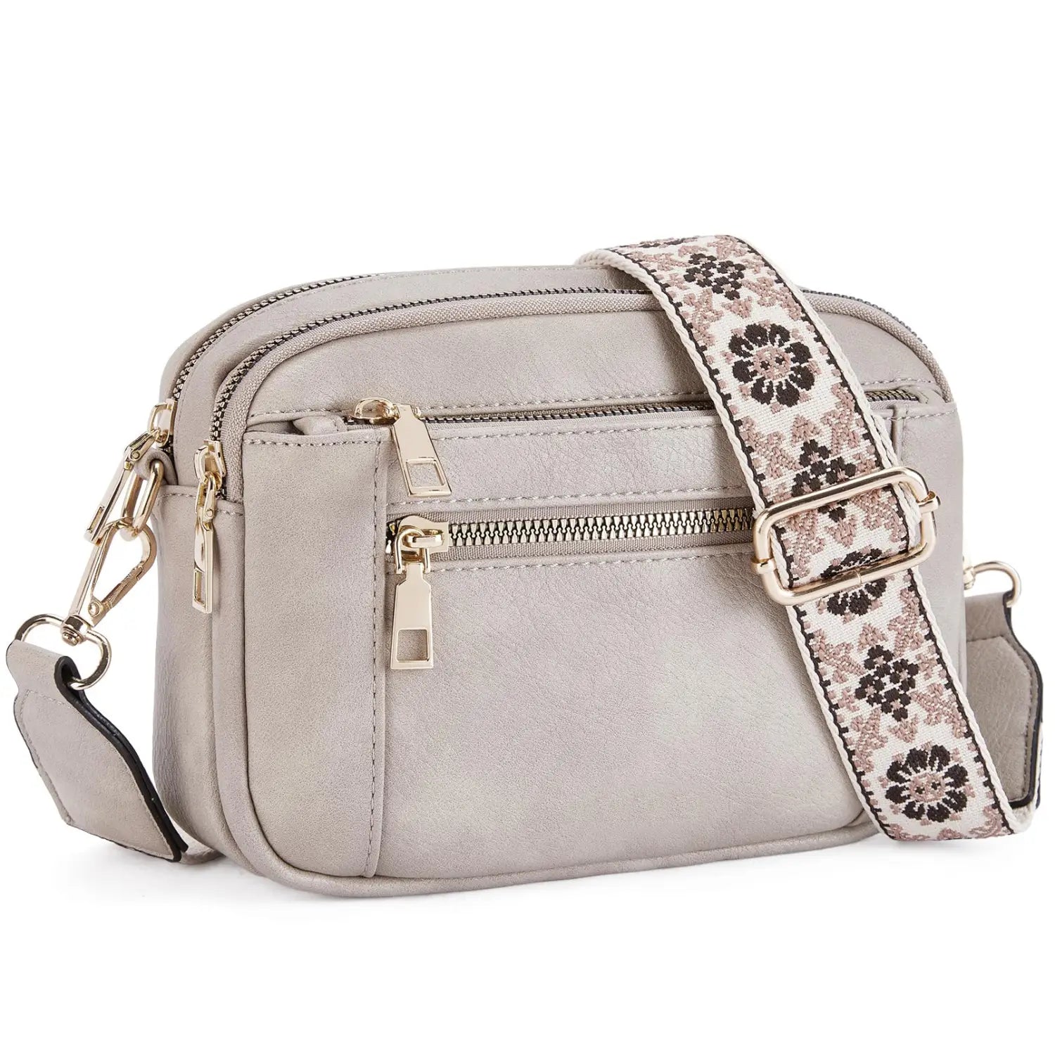 A light gray triple zipper colorblock crossbody bag with multiple compartments and a floral-patterned strap.