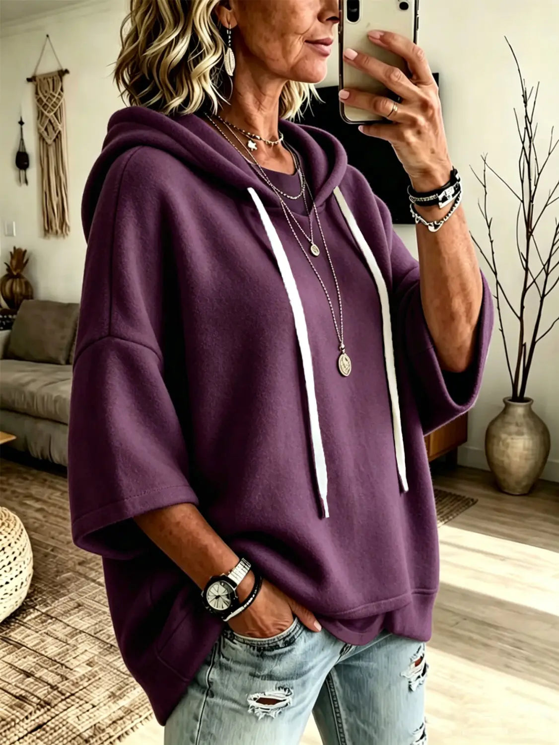 Purple oversized fleece hooded top with three-quarter sleeves featuring white drawstrings.