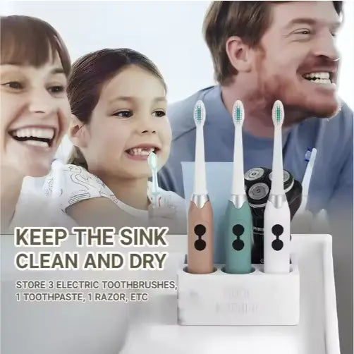 Three electric toothbrushes in beige teal and white with silver accents stand upright in a ceramic toothpaste holder marble bathroom organizer with a sleek white design.