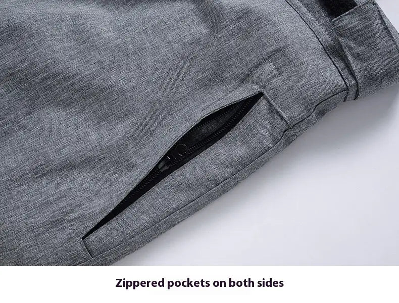Men waterproof thermal snow pants in gray heathered fabric featuring a side zipper pocket.