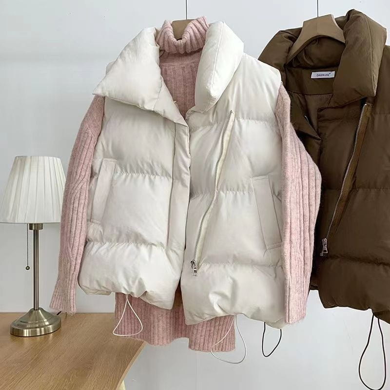Cream-colored quilted puffer vest with high collar and pink ribbed knit sleeves for women loose sleeveless outerwear.