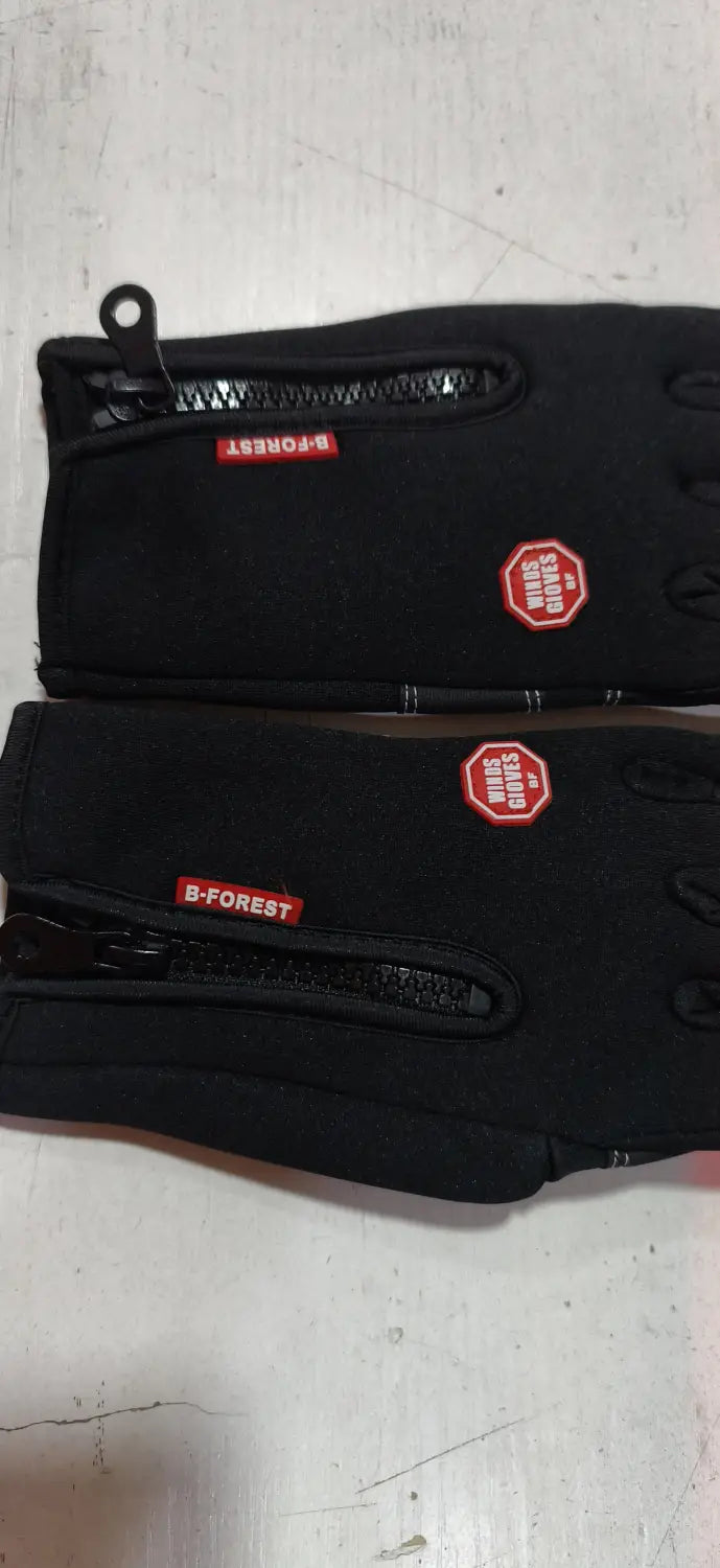 black b-forest branded windproof touchscreen winter gloves for men and women shown from the back with red zipper pulls and octagonal logo patches.