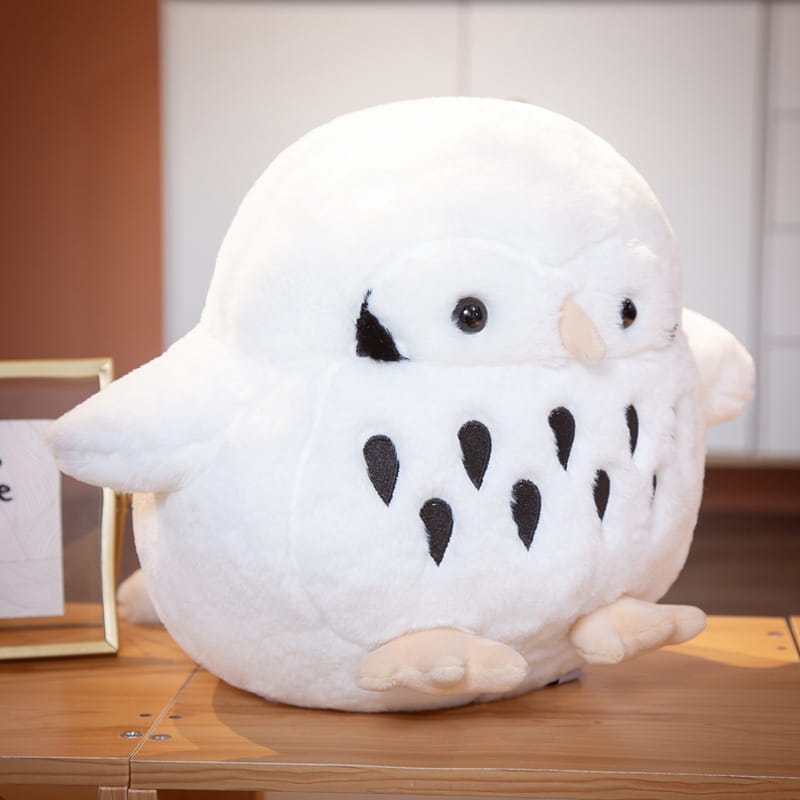 A plush white owl stuffed animal with black teardrop-shaped markings and tan feet made of soft fabric material for a round soft doll toy.