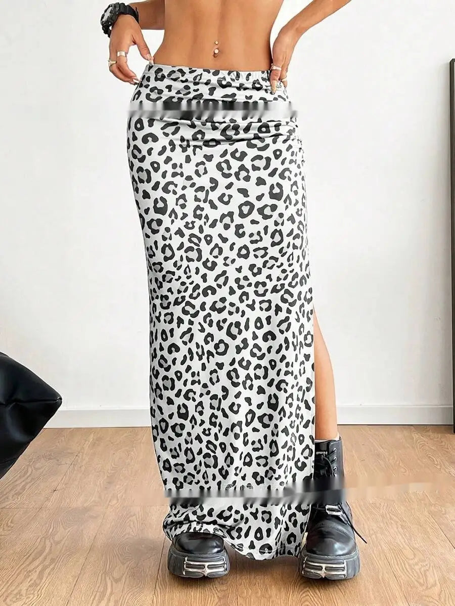 A black and white leopard print high waisted maxi skirt with a side slit and flowing fabric.