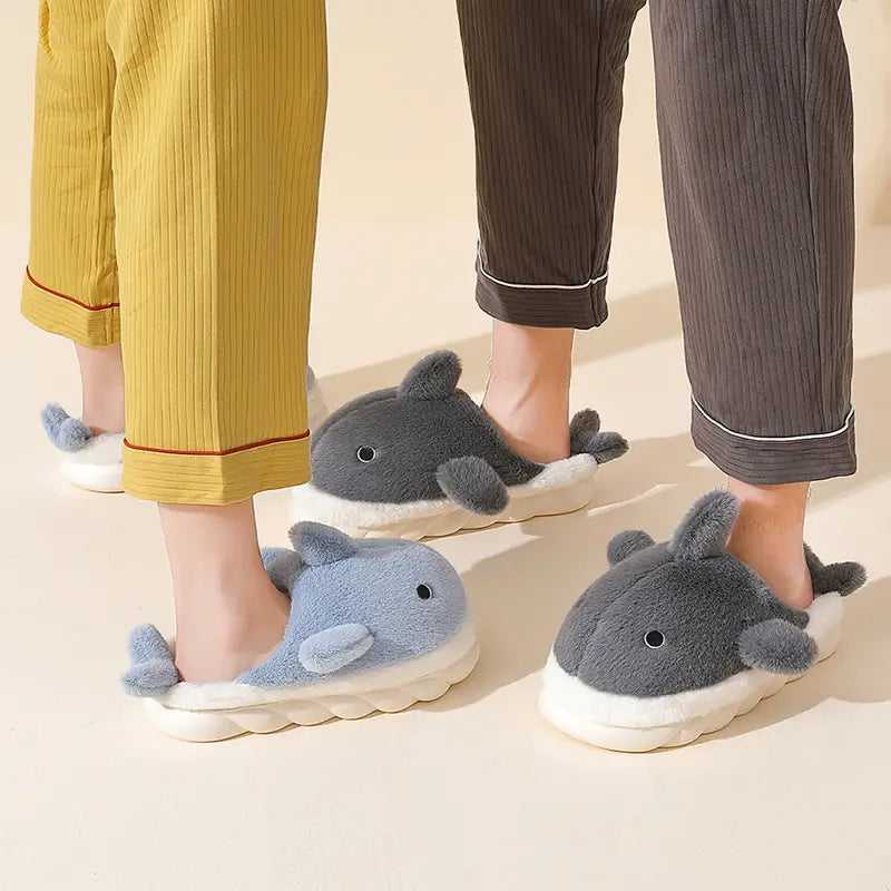 Soft plush whale-shaped shark slippers in gray and light blue with white soles designed as animal dolphin whale house shoes.