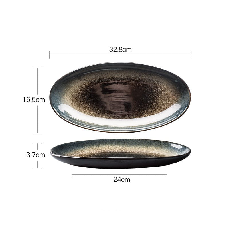 Elegant oval ceramic plate from a ceramic tableware set featuring a black and gold kiln glaze porcelain with a glossy finish and subtle speckled texture.