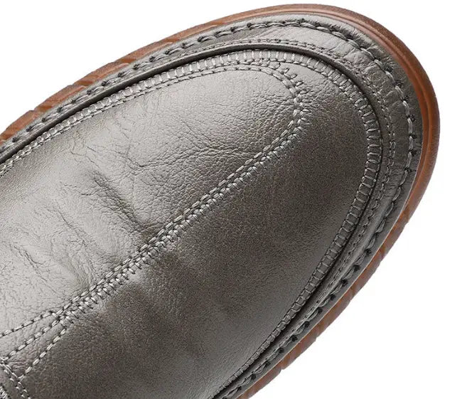 Men’s breathable non slip gray leather slip-on loafers with textured sole and visible stitching.