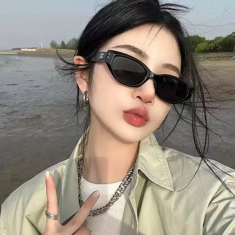 Black retro cat eye uv400 sunglasses with glossy modern frames and dark lenses.