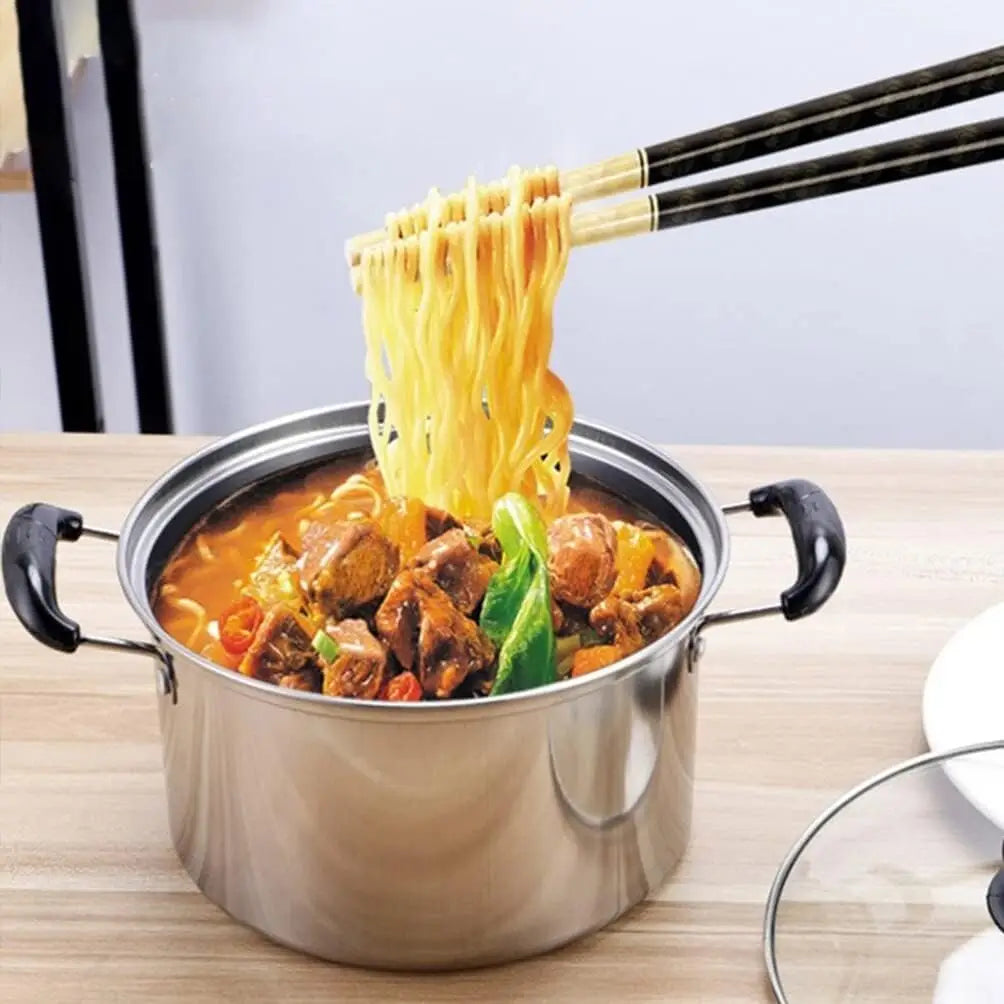 A stainless steel pot with black handles from the Stainless Steel Induction Cookware Set 5 Pieces filled with hearty noodle stew being lifted by chopsticks.